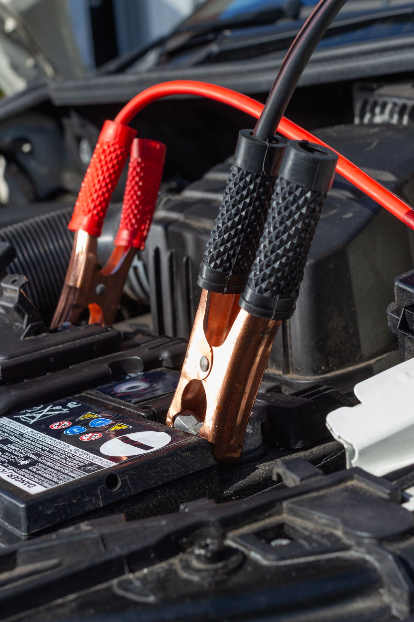 Jumper cables connected to a car battery
